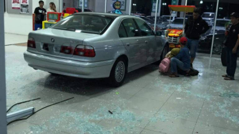 Car rams into glass door at shopping mall