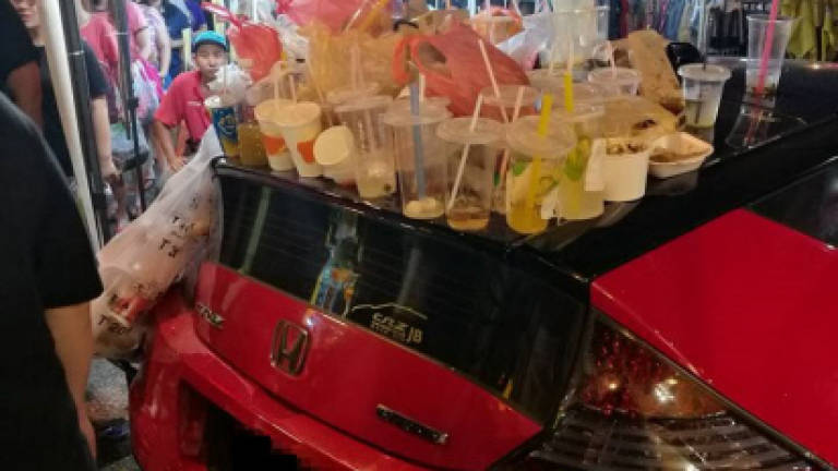 Malaysians turn parked car into trash can