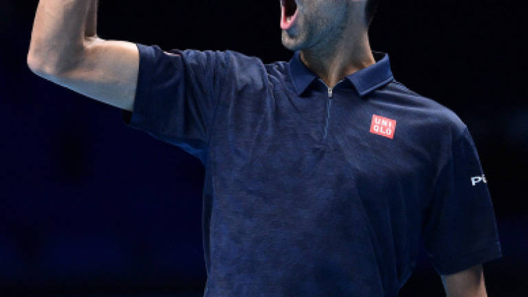 Djokovic beats Raonic to book last four spot at Tour Finals
