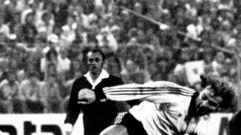 This file photo taken on September 17, 1974 at the Waldstadion in Frankfurt am Main, western Germany, shows Monaco’s French midfielder Georges Prost (L bottom) fighting for the ball with Frankfurt’s German center forward Bernd Hölzenbein (R) during the football match Eintracht Frankfurt vs AS Monaco of the 1974–75 European Cup Winners’ Cup/AFPPix