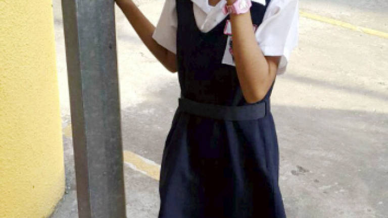Girl chained to lamp post for refusing to go to school