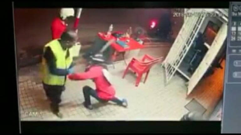 Suspect held after CCTV clip of armed robbery goes viral (Updated)