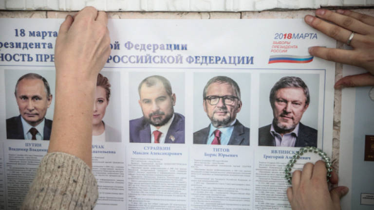 Isolated but defiant, Russia set to re-elect strongman Putin