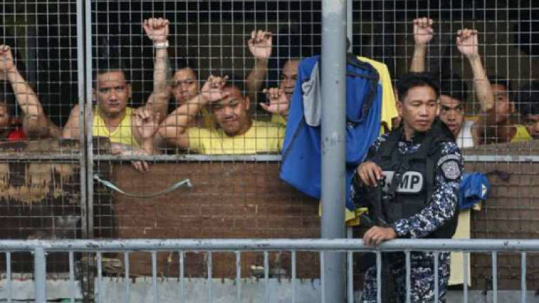 Overturned pail sparks deadly riot at overcrowded Philippine jail