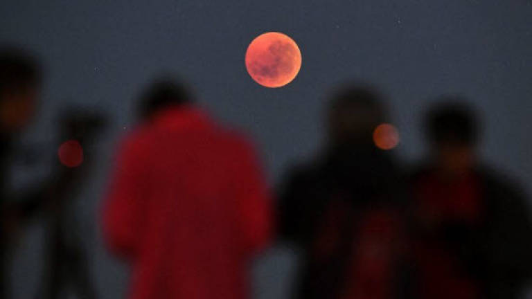 'Blood moon' dazzles skygazers in century's longest eclipse