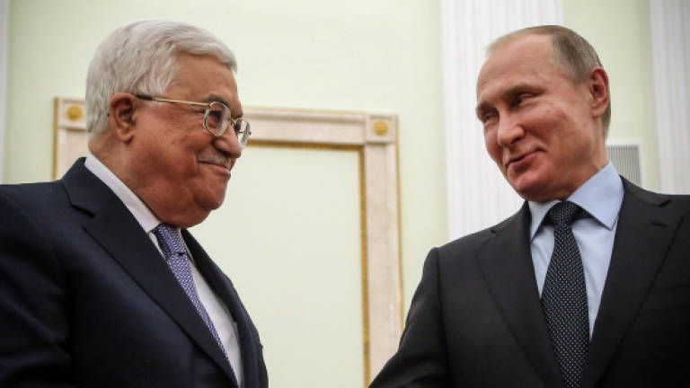 Putin discusses Mideast with Trump, hosts Abbas