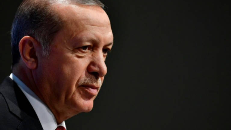 Turkey puts on trial 17 staff from anti-Erdogan daily