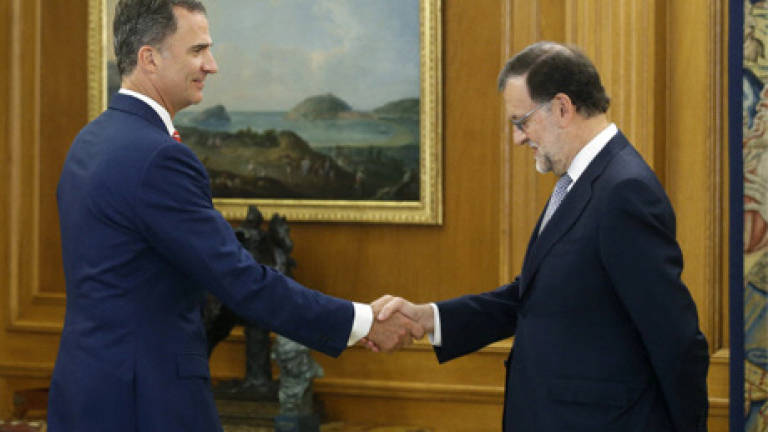 Spain king tasks acting PM Rajoy with forming new government