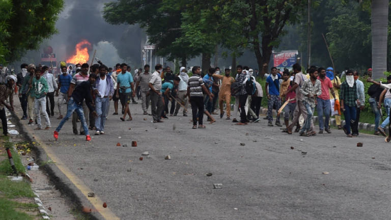 Clashes kill 32 in India as court convicts guru of rape