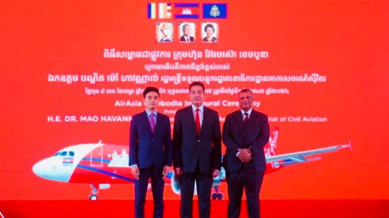 From left: Vissoth, Minister in Charge of State Secretariat of Civil Aviation Dr Mao Havannall and Fernandes at the commemoration ceremony of AirAsia Cambodia in Phnom Penh today. – AirAsia pic
