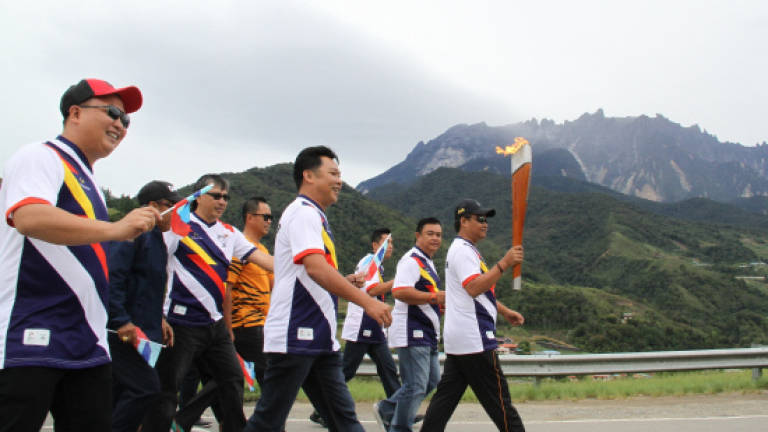 Strong winds, bad weather fail to stop KL 2017 torch from reaching peak of Mount Kinabalu