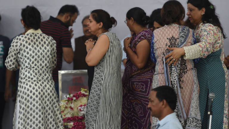 Families of Bangladesh cafe victims take bodies home