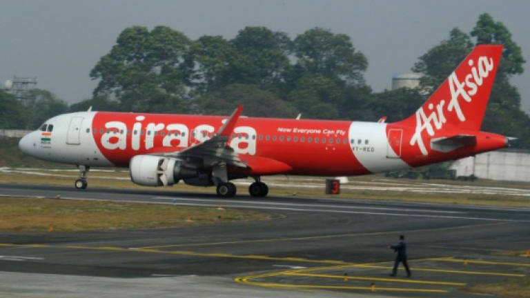 Indian man tries to open AirAsia plane's emergency door in midair