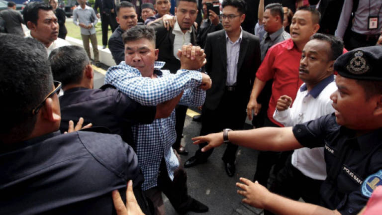 Group of 12 surrender over Parliament fracas