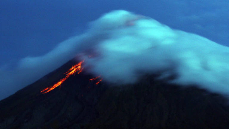 Rushed evacuations as Philippine volcano spews lava