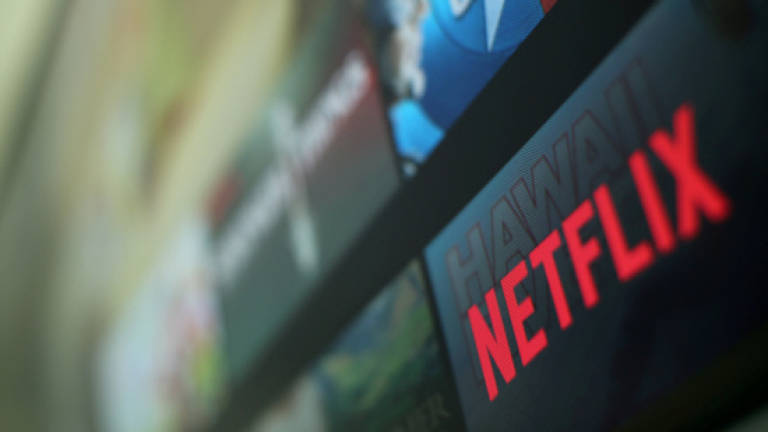 Netflix shares jump as subscriptions top 100 million