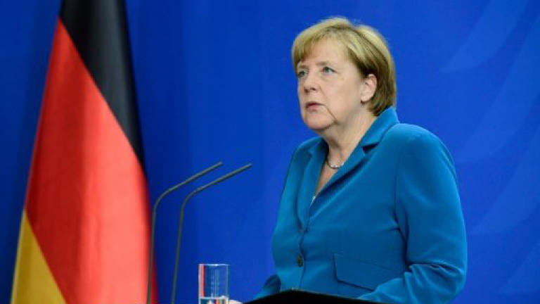 Merkel faces hot summer over refugee stance after attacks