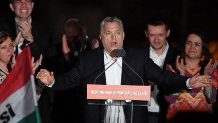 Hungary's PM Orban claims victory as his party takes sweeping poll lead
