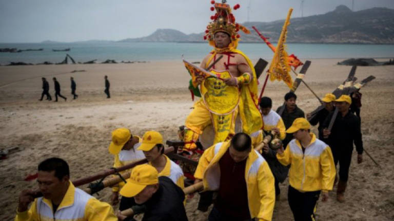 Chinese fishermen seek divine blessings in troubled waters