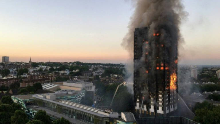 UK PM bows to pressure on deadly tower block fire inquiry