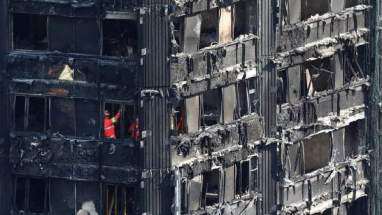 Police consider manslaughter charges over London blaze as thousands evacuated
