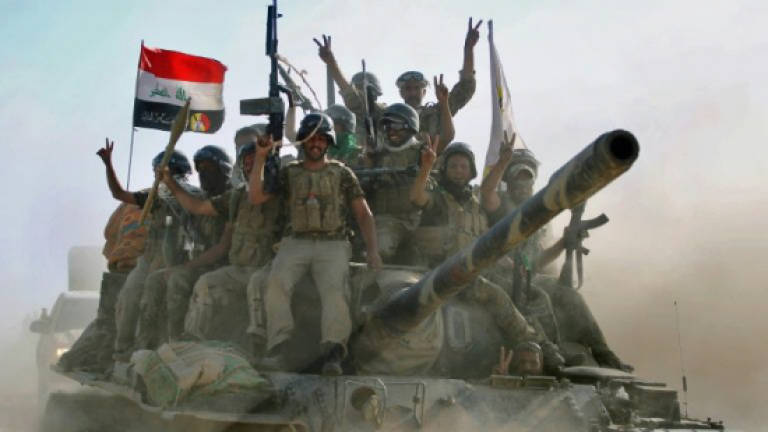 Iraqi forces retake three districts of IS bastion