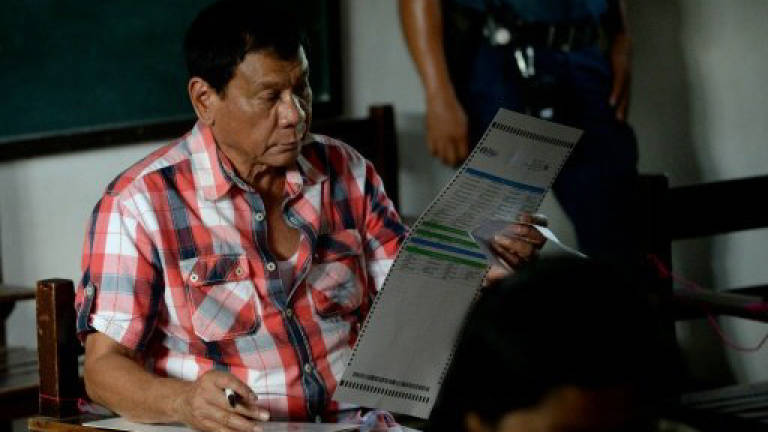 Duterte claims Philippine presidency, vows crime crackdown
