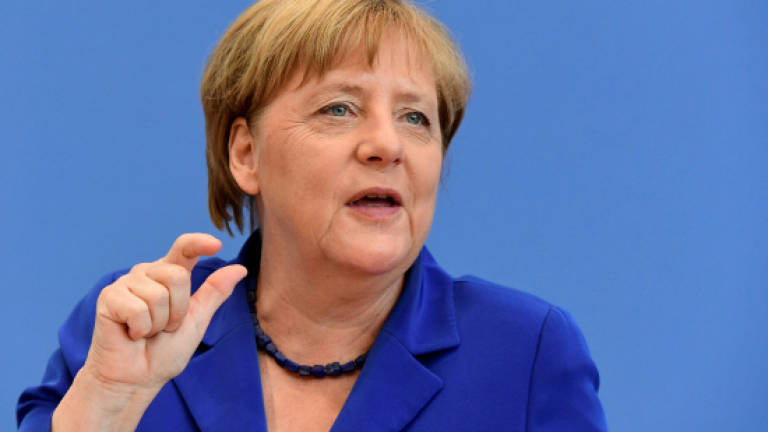 Merkel 'firmly' rejects reversing refugee policy after attacks