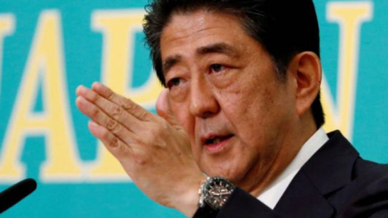Japan's Abe claims victory in parliamentary vote