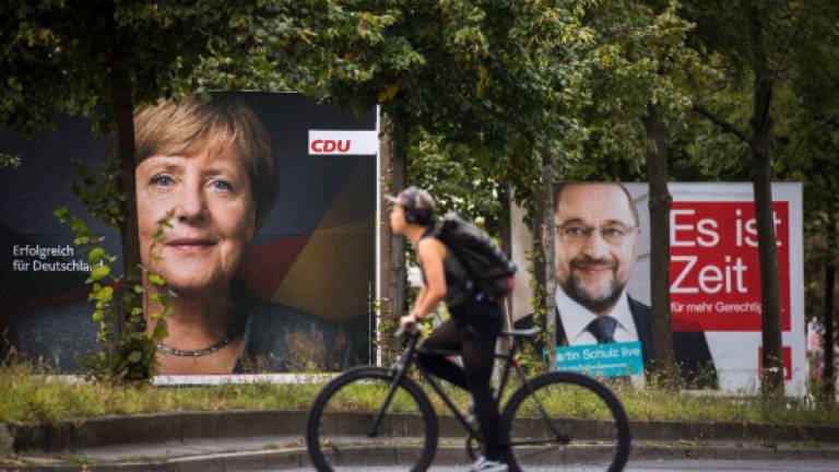 'Bring home the bacon,' Merkel tells voters on eve of poll