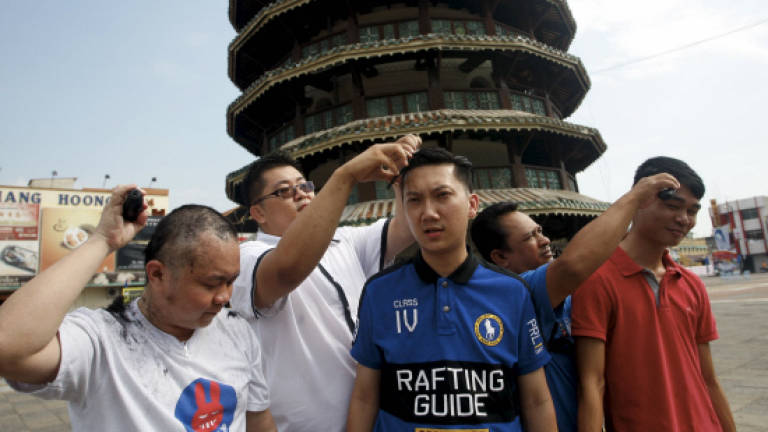 BN youths go bald to protest DAP'S 'dirty tactics' in Teluk Intan