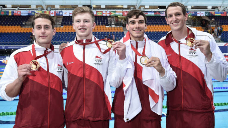 England upset Australia to hit 10 swim golds
