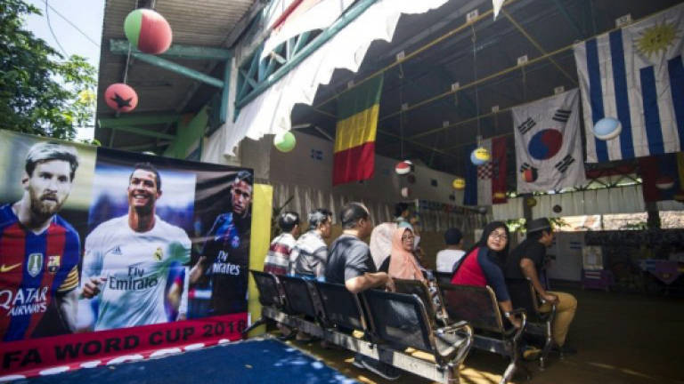 Ronaldo pics, 'ghostly' officials draw voters in Indonesia polls
