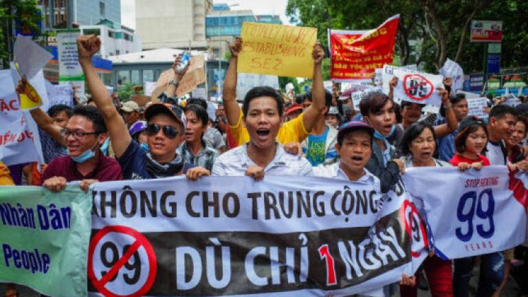 Vietnam detains 100 after protests turn violent