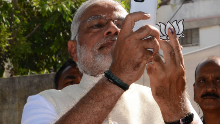 India's Modi votes, snaps 'selfie' in latest election leg