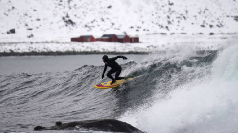 Surfing: Pushing the limit riding Norway's frozen waves