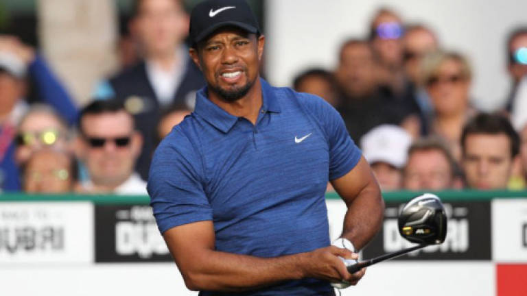 Woods withdraws from Dubai with back spasm