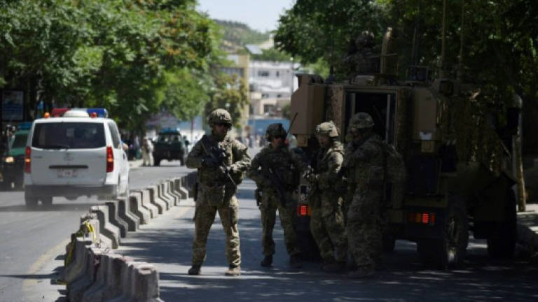 Gunmen kill eight Afghan guards at largest US base
