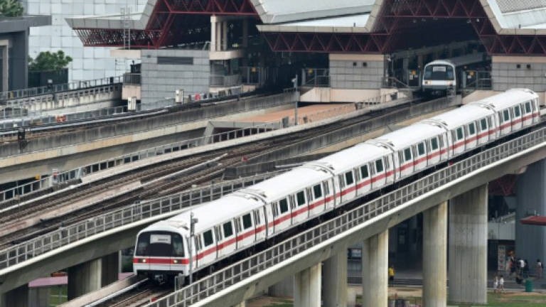 Singaporeans charged over US$7m metro scandal