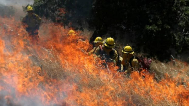 Wildfires rage as California sizzles