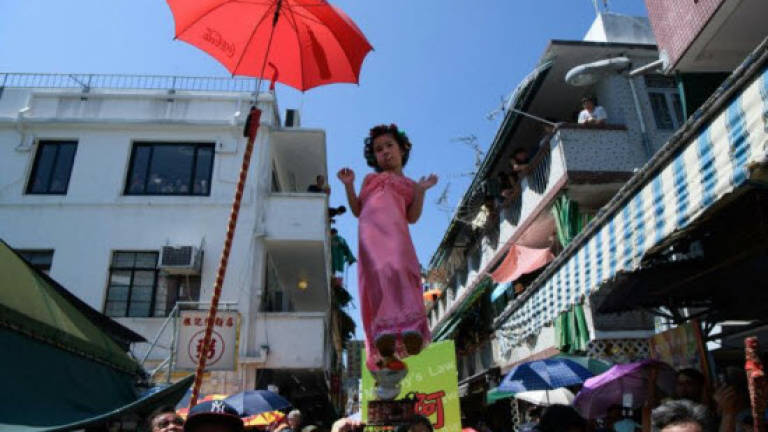 Hovering kids go political in Hong Kong festival parade