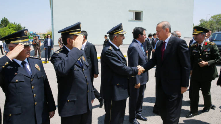 Turkey dismisses 1,400 troops as Erdogan tightens grip
