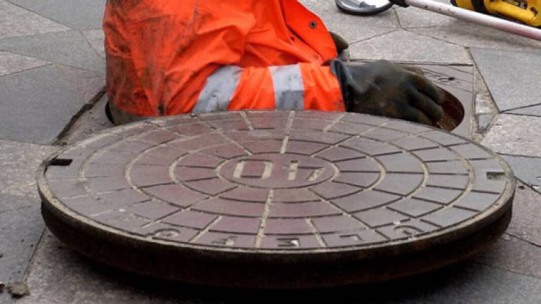 Two workers found dead in manhole