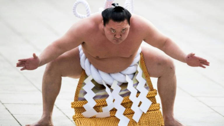Sumo champ Hakuho wins tournament as scandal rocks national sport