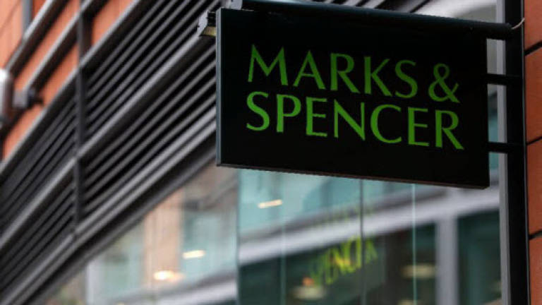 M&amp;S says annual profits tumble on restructuring