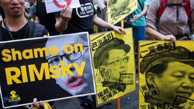 Crowds rally in Hong Kong after activists jailed