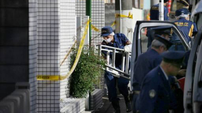 Japan minister sorry as 6,000 police hunt fugitive thief
