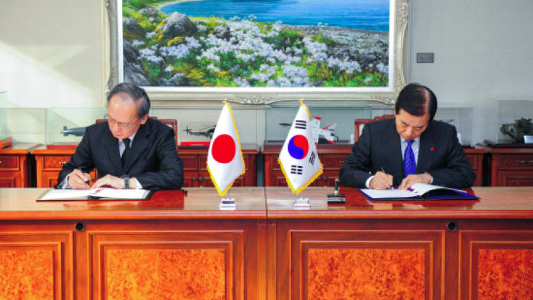 S. Korea, Japan sign controversial intelligence deal