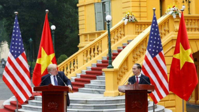 Trump rails at Vietnam trade imbalance as deals signed in Hanoi