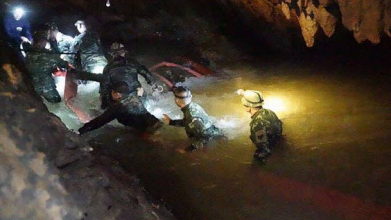 Thai boys spend eighth night in flooded cave as weather eases
